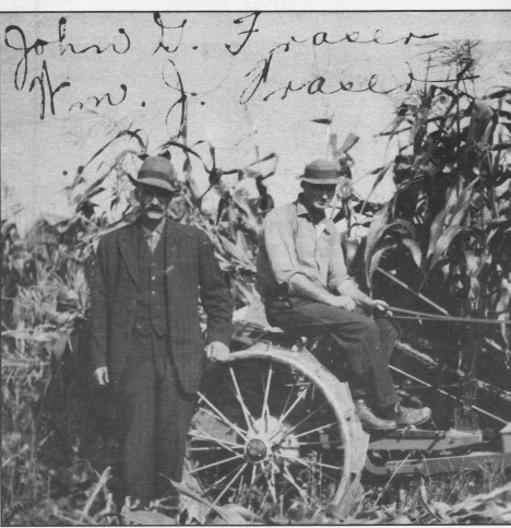 John G. Fraser and his son, William J., in the cornfield at their LaPrairie farm, about 1919.